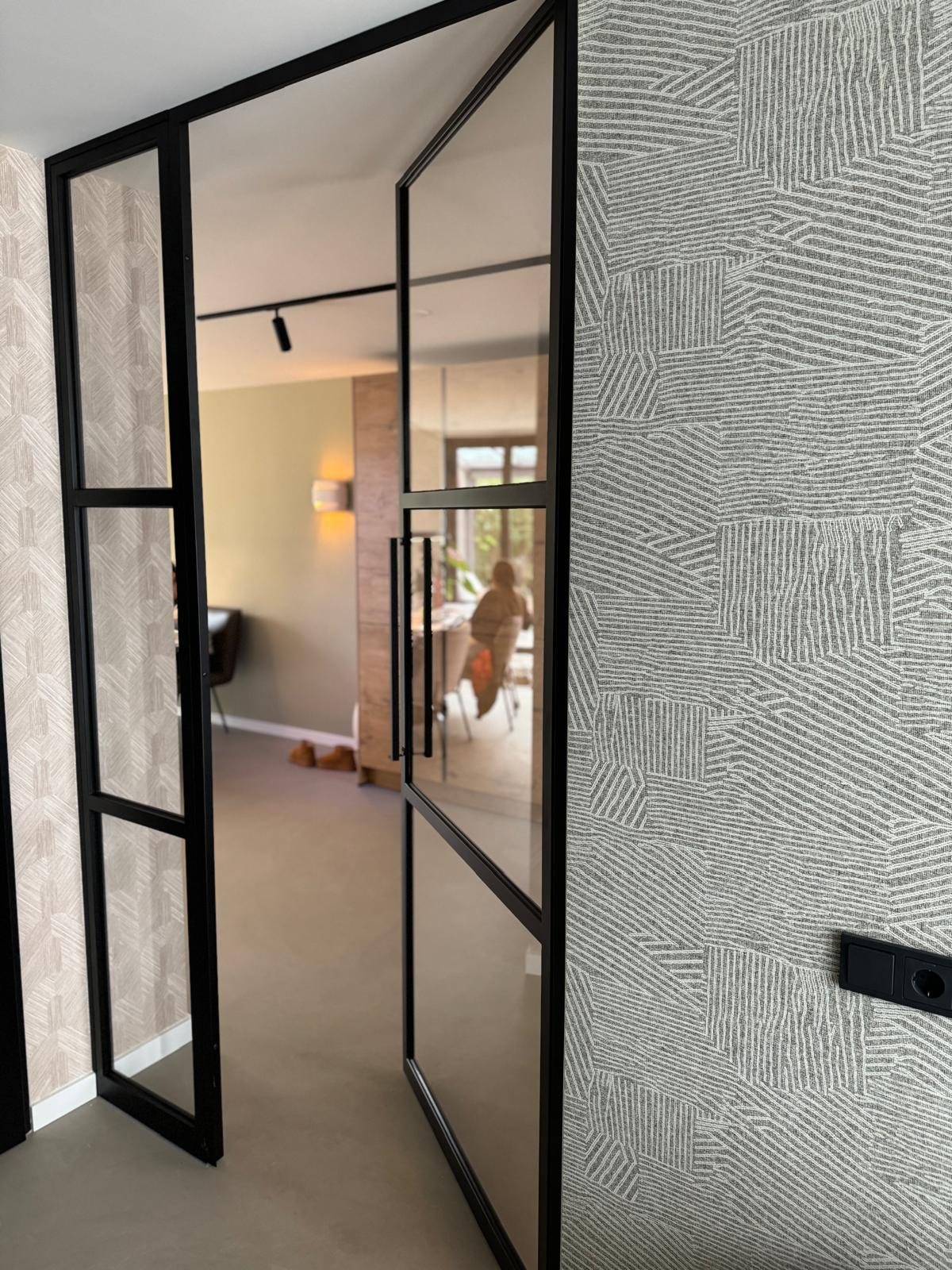 Stalen deur met glas tussen gang en woonkamer